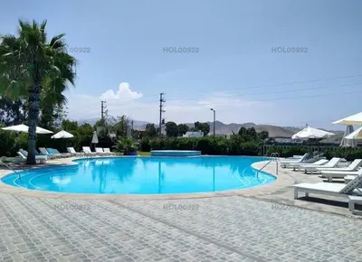 a large swimming pool with chairs and umbrellas at Casa en Asia in Asia