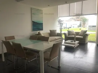 a living room with a table and a couch at Casa en Asia in Asia