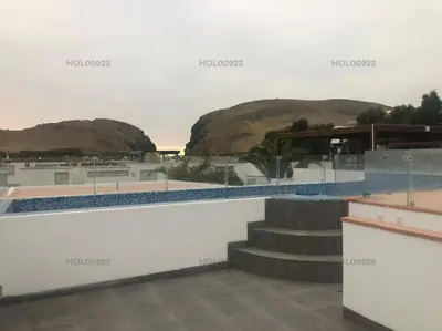 a swimming pool with stairs and mountains in the background at Casa en Asia in Asia