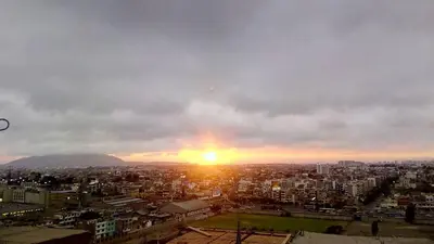 a view of a city with the sunset in the sky at A great experience in the South cone of Lima! in Lima