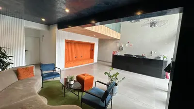 a living room with a couch and chairs and a table at Modern 2Br Apt Fully Furnished Barranco in Lima