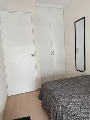 a bedroom with white cabinets and a bed with a mirror at Modern 2Br Apt Fully Furnished Barranco in Lima