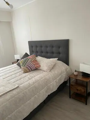 a bed with two pillows on it in a bedroom at Departamento amoblado de 1 dormitorio in Lima