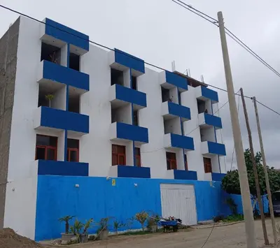 a blue and white building with blue balconies at Hostal Lobitos in Cerro Azul