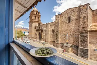 a plate on a window sill with a view of a building at Vista Qoricancha - 2 cuadras Plaza Principal in Cusco