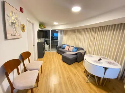 a living room with a couch and a table and chairs at Vista piso 24 in Lima