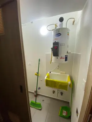 a bathroom with a sink and a cleaning machine at Vista piso 24 in Lima