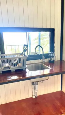 a kitchen counter with a sink and a window at Cabaña2 con hermosa vista al valle in Oxapampa