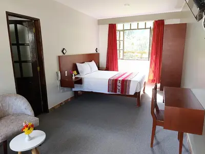 a hotel room with a bed and a window at Samana House Ollantaytambo in Ollantaytambo
