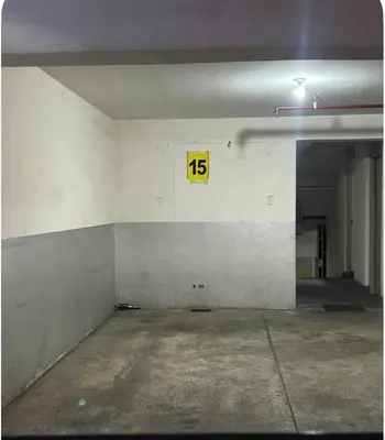 an empty parking garage with a sign on the wall at Comodidad y Exclusividad in Lima
