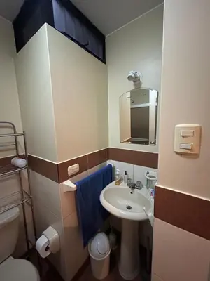 a bathroom with a sink and a toilet and a mirror at Comodidad y Exclusividad in Lima