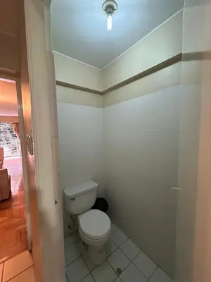 a bathroom with a white toilet in a room at Comodidad y Exclusividad in Lima