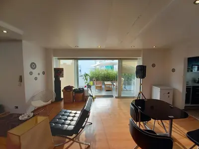a living room with a couch and a table at Loft Minimalista de Lince in Lima