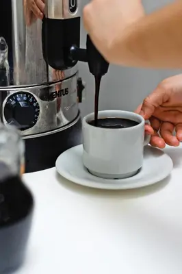 a person is making a cup of coffee at San Miguel Awanka Hotel in Lima