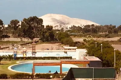 a resort with a pool and a mountain in the background at Duplex con piscina en Asia in Asia