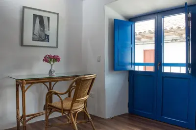 a blue door in a room with a table and a chair at Quinta San Blas by Ananay Hotels in Cusco