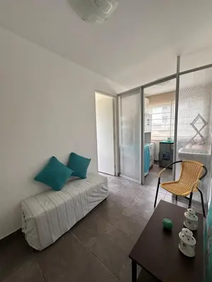 a living room with a bed and a table at Mirador 101 in Asia