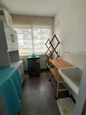 a kitchen with a sink and a table and a window at Mirador 101 in Asia