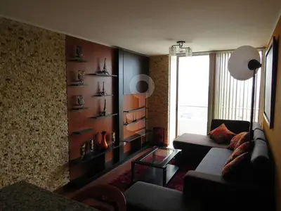a living room with a couch and a window at Temporal Apartment in Lima