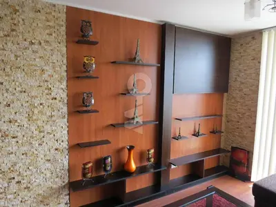 a wall with wooden shelves in a room at Temporal Apartment in Lima
