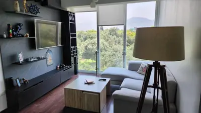 a living room with a couch and a large window at Apartamento de Lujo in Lima