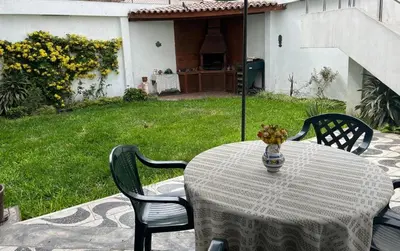 a table and chairs with a vase of flowers on it at Casa Extremadura in Lima