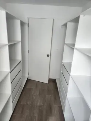 an empty closet with white shelves and a door at Apartamento en Lima in Lima