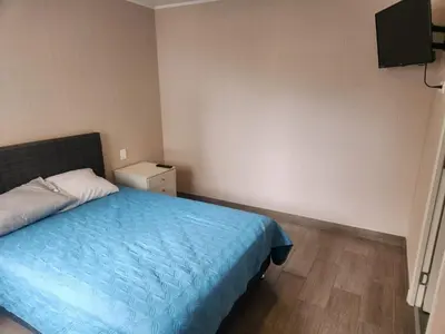 a bedroom with a bed with a blue blanket at Apartamento en Lima in Lima