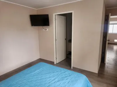 a bedroom with a bed and a flat screen tv at Apartamento en Lima in Lima
