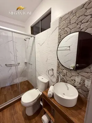 a bathroom with a toilet and a sink and a mirror at Grand Hotel Megantoni in Quillabamba