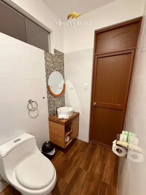 a bathroom with a toilet and a sink at Grand Hotel Megantoni in Quillabamba