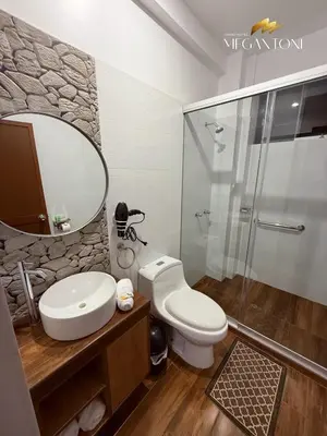 a bathroom with a toilet and a sink and a shower at Grand Hotel Megantoni in Quillabamba