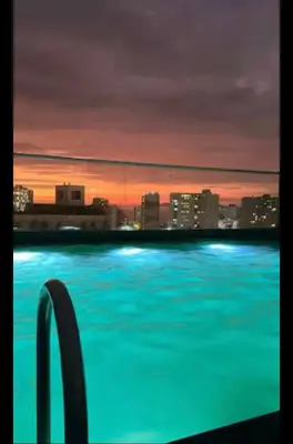 a swimming pool with a view of a city at night at Luxury Barranco Pool Zoe in Lima