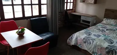 a hotel room with a bed and a table and chairs at Habitación A1 Trabajar Kitchenette y baño privado in Lima