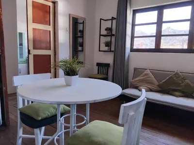 a living room with a table and a couch at Apartment in the historic center of Cusco in Cusco