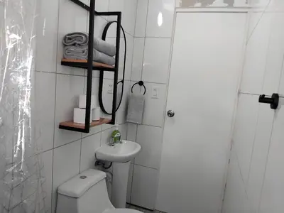 a small bathroom with a toilet and a sink at Apartment in the historic center of Cusco in Cusco