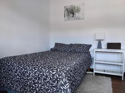 a bedroom with a black and white bed and a nightstand at Apartment in the historic center of Cusco in Cusco