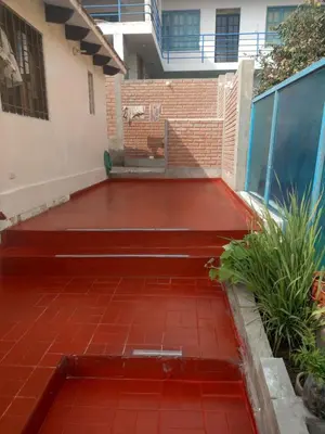 a patio with a red tile floor in front of a building at Relaxing Bungalow in Santa Rosa