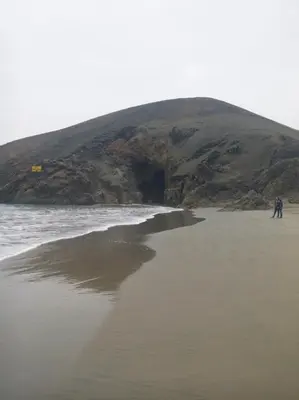 two people walking on a beach near the ocean at Relaxing Bungalow in Santa Rosa