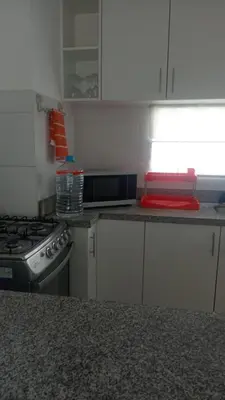 a kitchen with a stove and a counter top at Departamento de playa in Asia