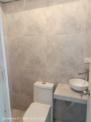a bathroom with a toilet and a sink at Mirador sur in San Bartolo