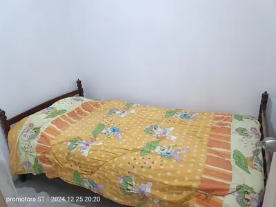 a bed with a blanket on top of it at departamento frente al mar in San Bartolo