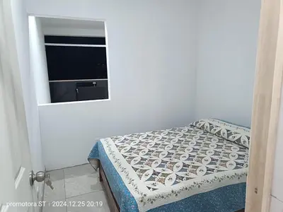 a small bedroom with a bed and a window at Mirador del sur in San Bartolo