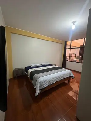 a bedroom with a bed in a room with a window at 2da Habitacion a 1 cuadra de la Plaza in Oxapampa