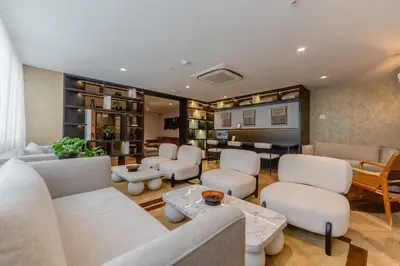 a waiting room with white chairs and tables at Hotel Límade in Lima