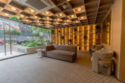 a lobby with a couch and chairs in a building at Hotel Límade in Lima
