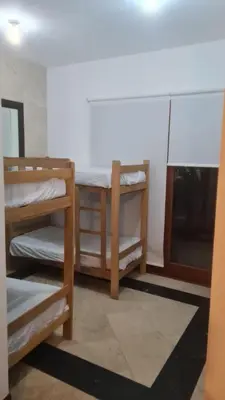 a room with two bunk beds and a window at Casa de Playa Familiar in Puerto Viejo