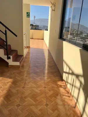 a hallway with wooden flooring in a building at HOTEL SAMANAHUASi in Nazca