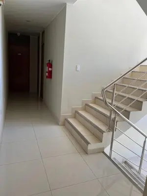 a hallway with stairs and a fire hydrant in a building at HOTEL SAMANAHUASi in Nazca