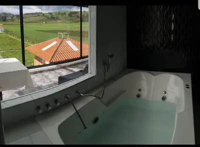 a white bath tub in a room with a window at Casa isaaleya in Cusco